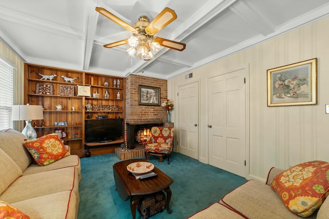 living room with a brick fireplace, dark carpet, built in features, ceiling fan, and beam ceiling