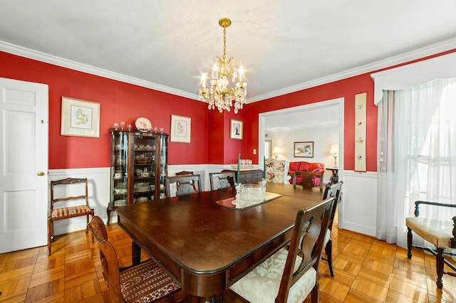 dining area featuring crown molding, light parquet flooring, beverage cooler, and a chandelier