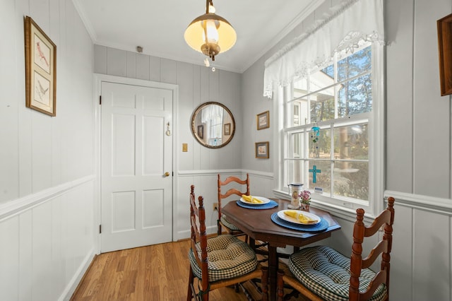 dining room featuring light hardwood / wood-style flooring and ornamental molding