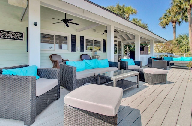 wooden deck with outdoor lounge area and ceiling fan