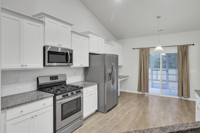 kitchen featuring white cabinetry, hanging light fixtures, stainless steel appliances, tasteful backsplash, and vaulted ceiling