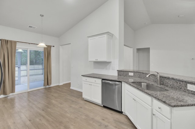 kitchen featuring hanging light fixtures, dark stone countertops, stainless steel dishwasher, and white cabinets