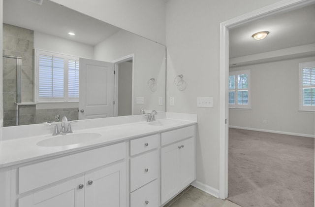 bathroom featuring vanity and a shower with door