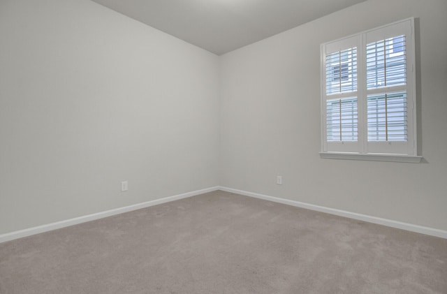 unfurnished room featuring light colored carpet