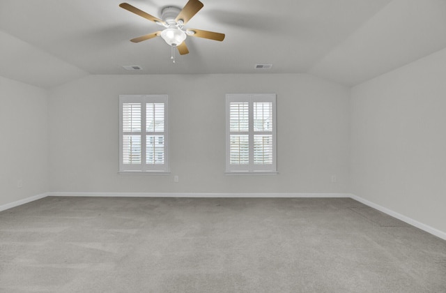 carpeted empty room featuring lofted ceiling and ceiling fan