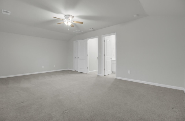 unfurnished room featuring lofted ceiling, light colored carpet, and ceiling fan