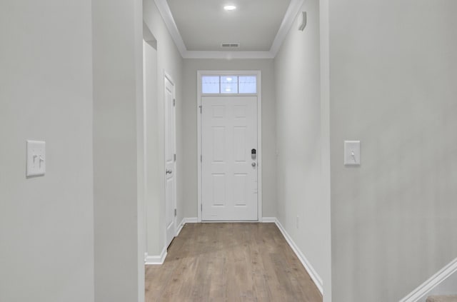 doorway to outside featuring crown molding and light hardwood / wood-style flooring