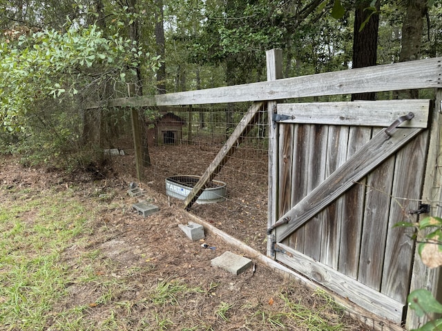 view of gate with an outdoor structure