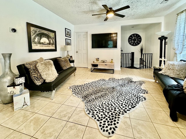 tiled living room featuring a textured ceiling and ceiling fan