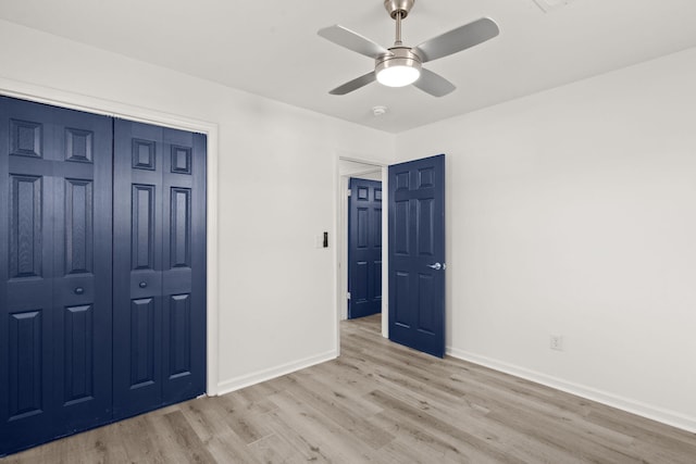 unfurnished bedroom with ceiling fan, light hardwood / wood-style floors, and a closet