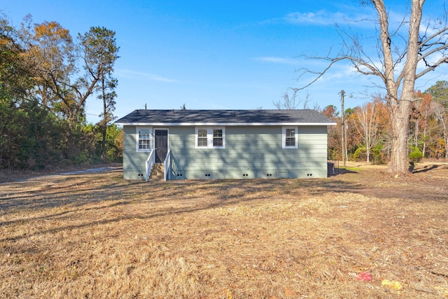 back of property featuring a yard