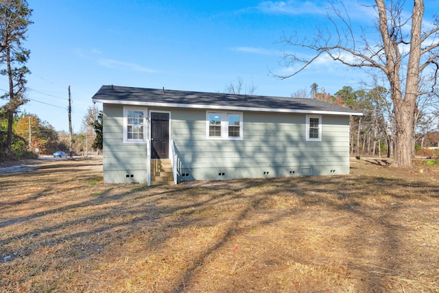 back of property featuring a yard