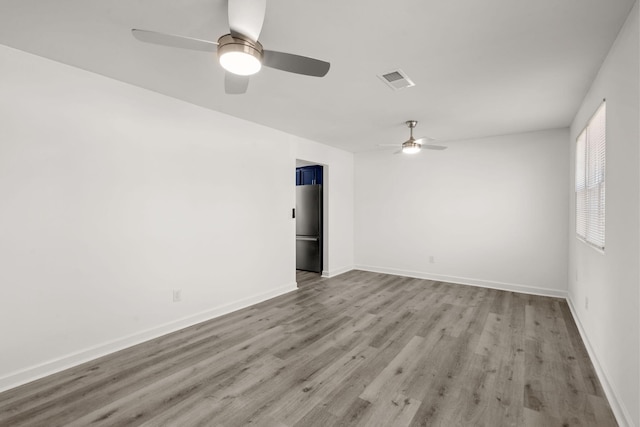 spare room featuring ceiling fan and light hardwood / wood-style flooring