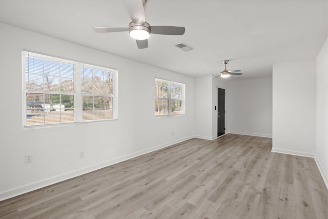 empty room featuring ceiling fan and light hardwood / wood-style flooring