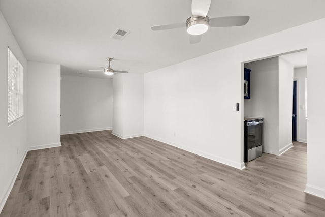 spare room featuring ceiling fan and light hardwood / wood-style floors