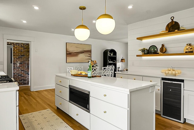 2456 Lantern St, Charleston, SC 29414 - kitchen with wine cooler, stainless steel microwave, light wood finished floors, white cabinets, and recessed lighting