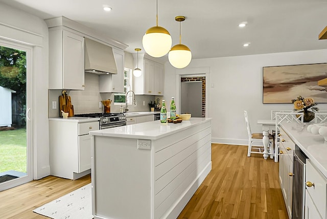 2456 Lantern St, Charleston, SC 29414 - kitchen with wall chimney exhaust hood, light wood-type flooring, light countertops, recessed lighting, and decorative backsplash