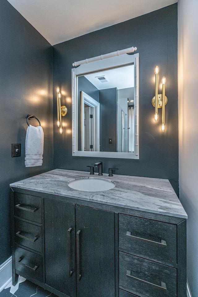 bathroom featuring baseboards, visible vents, and vanity