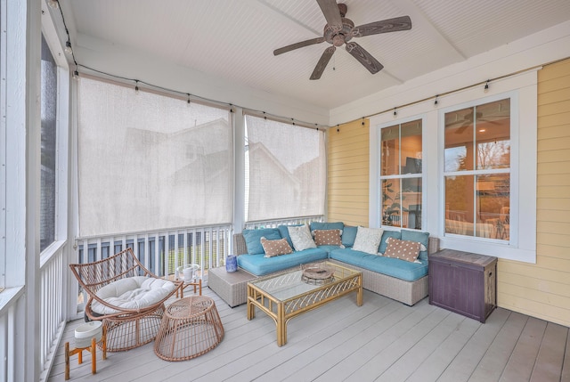 sunroom / solarium featuring ceiling fan