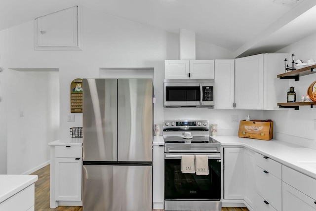 kitchen featuring white cabinets, lofted ceiling, open shelves, light countertops, and appliances with stainless steel finishes