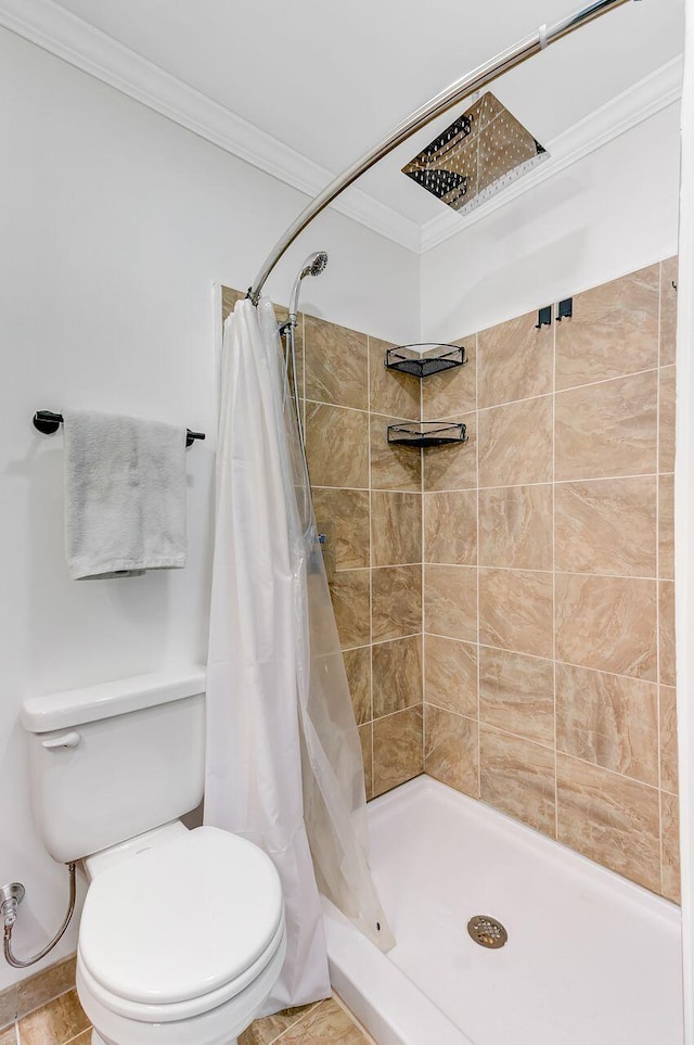 full bath with toilet, crown molding, and a stall shower