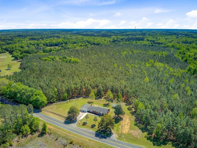 birds eye view of property with a view of trees