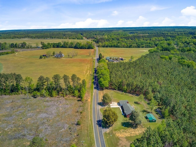 birds eye view of property featuring a rural view and a forest view