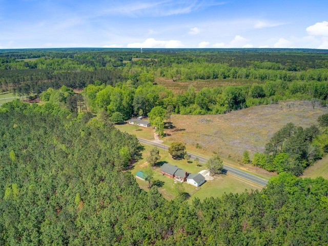 birds eye view of property with a wooded view