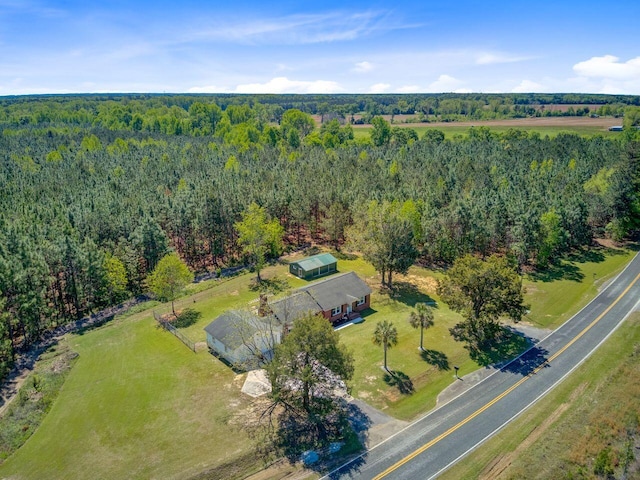 drone / aerial view featuring a wooded view