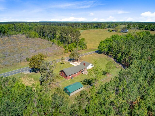 drone / aerial view featuring a rural view and a view of trees