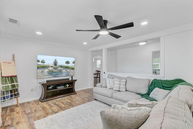 living room featuring wood finished floors, ceiling fan, ornamental molding, visible vents, and recessed lighting