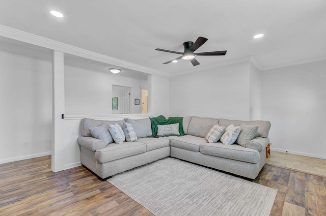 living room featuring wood finished floors, crown molding, baseboards, and a ceiling fan