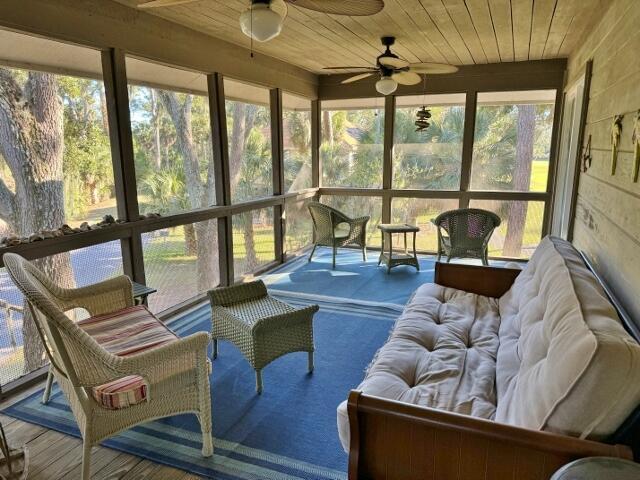 sunroom with wooden ceiling and ceiling fan