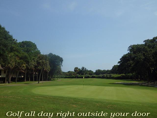 view of property's community with view of golf course and a yard