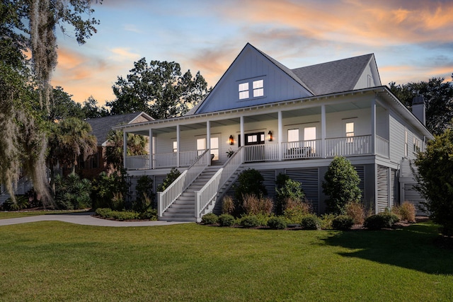 view of front of house with a yard and a porch