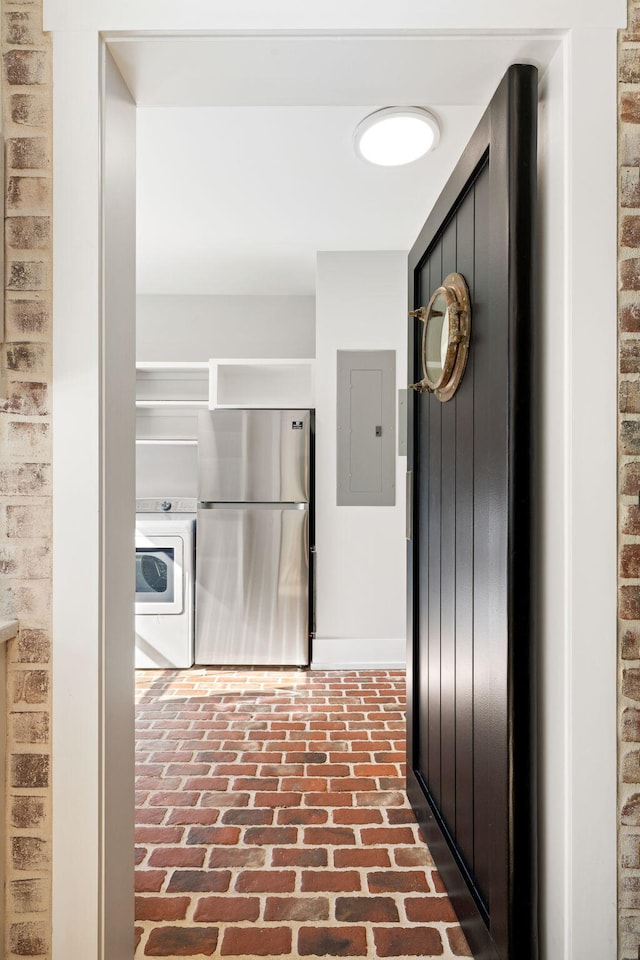 hall featuring washer / dryer and electric panel