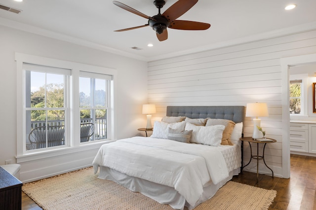 bedroom featuring ceiling fan, ornamental molding, and dark hardwood / wood-style flooring