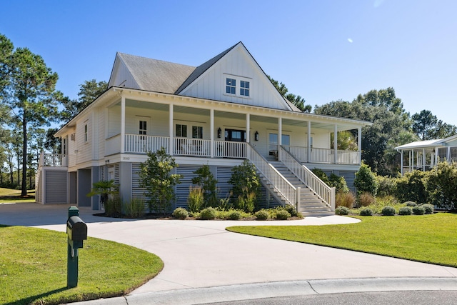 farmhouse inspired home with a front lawn and covered porch