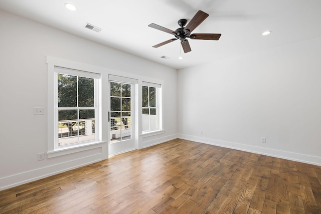 unfurnished room featuring ceiling fan and dark wood-type flooring