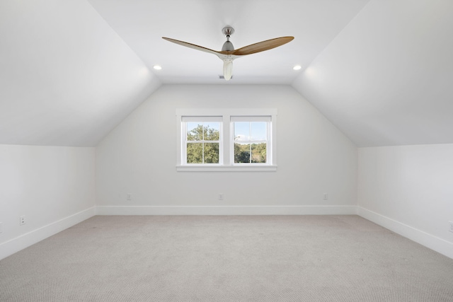 additional living space featuring lofted ceiling, ceiling fan, and light colored carpet