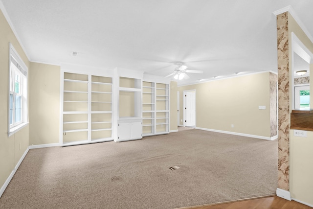 carpeted spare room with ornamental molding and ceiling fan