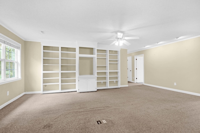 empty room with crown molding, light colored carpet, and ceiling fan