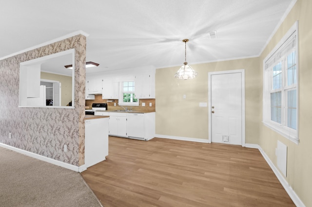 kitchen featuring black range with electric stovetop, decorative light fixtures, ornamental molding, white cabinetry, and light wood-type flooring