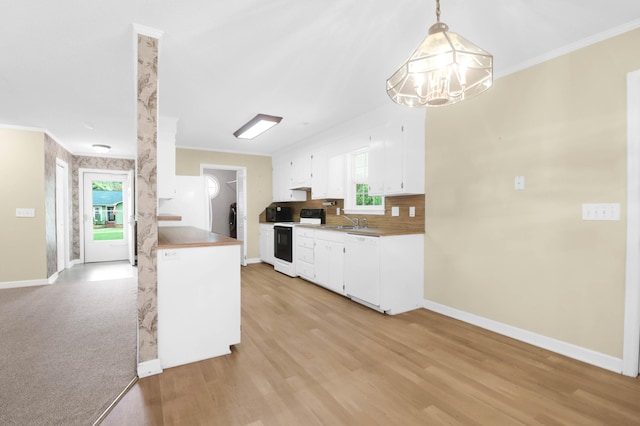 kitchen with decorative light fixtures, white appliances, white cabinetry, and a healthy amount of sunlight