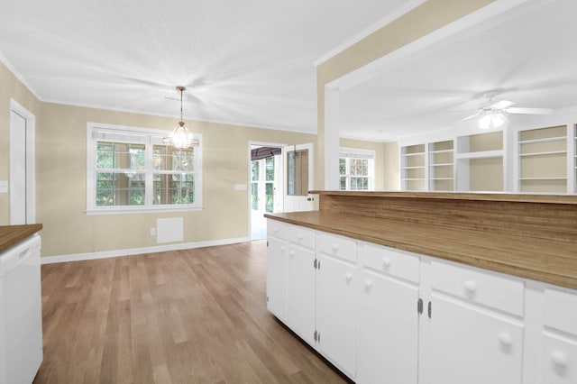 kitchen featuring light wood-type flooring, white dishwasher, white cabinetry, and a healthy amount of sunlight