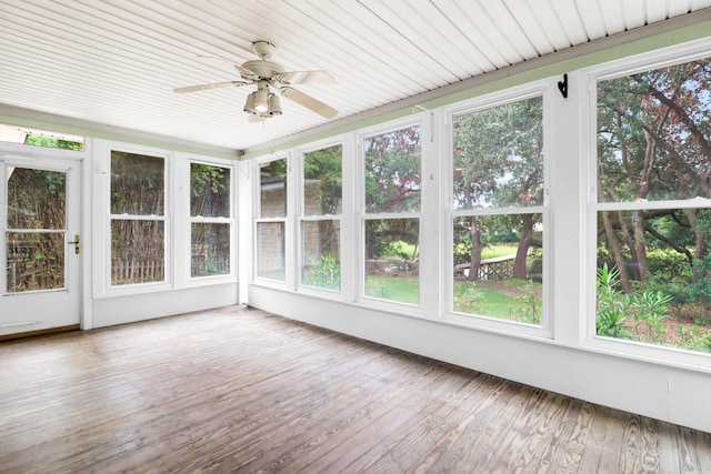 unfurnished sunroom featuring ceiling fan