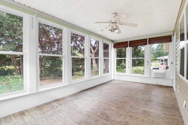 unfurnished sunroom featuring ceiling fan and a healthy amount of sunlight