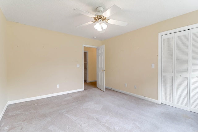 unfurnished bedroom featuring light colored carpet, ceiling fan, and a closet