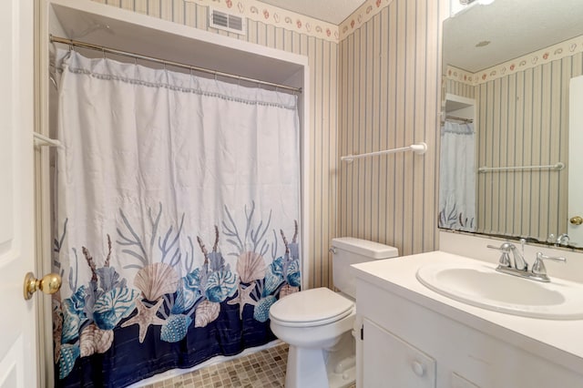 bathroom with vanity, toilet, a shower with shower curtain, and a textured ceiling