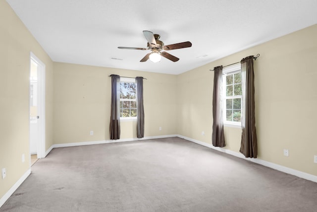 empty room with ceiling fan and carpet flooring